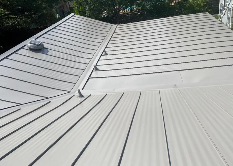 Solar attic fan installed on a metal roof for Roof Ventilation in Mountain Brook